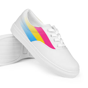A pair of white lace-up shoes with a colorful geometric pattern on the side.